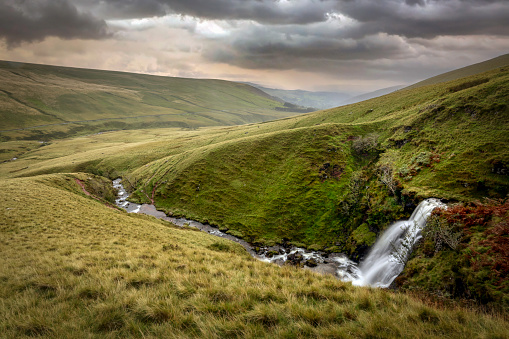 Heavy weather over one of a series of waterfalls that roll down the mountains in the Brecon Beacons in South Wales UK