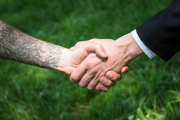 istock Tattoo man and businessman handshake 170100664