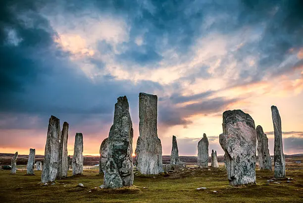 The ancient standing stones of Callanish (or Calanais) on Lewis in the Outer Hebrides of Scotland at sunrise. Built about 5000 years ago, the deeply textured stones of Callanish are arranged in allignments of avenues and a central circle not unlike a celtic cross.
