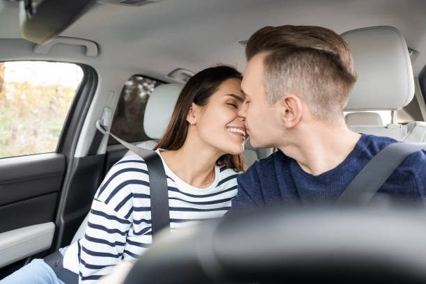 istock Happy young couple doing nose rub in car 1701013633