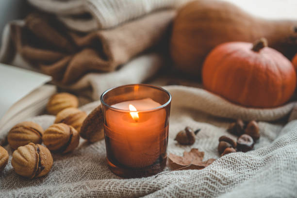 istock Burning candle in a cozy autumn interior 1701018669