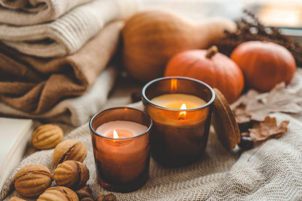istock Two burning candles in the autumn interior 1701018670