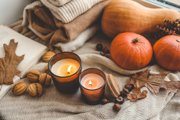 istock Two burning candles in the autumn interior 1701018671