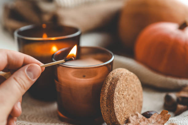 istock Match in hand lights a candle, cosiness concept 1701018675