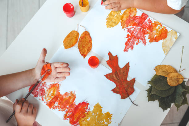 istock Children color the leaves and make a print, autumn creativity 1701021981