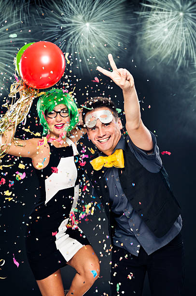 istock New Year's couple having fun, celebrating, fireworks on sky, night 170102592