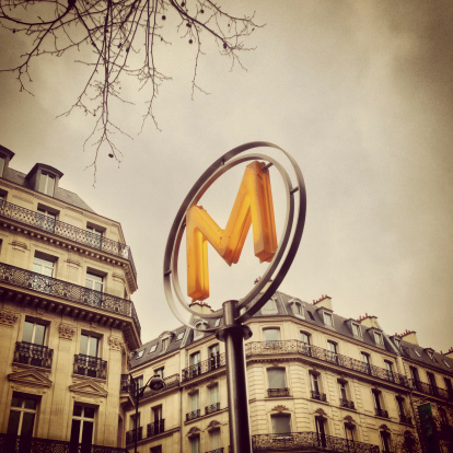 Phone cam photograph of the iconic Paris Metro sign in central Paris, France. Taken with an iPhone 5, processed with Instagram.