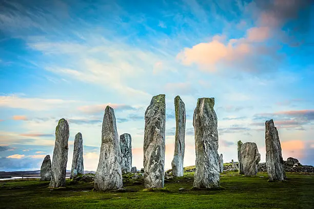 The ancient standing stones of Callanish (or Calanais) on Lewis in the Outer Hebrides of Scotland at sunrise. Built about 5000 years ago, the deeply textured stones of Callanish are arranged in allignments of avenues and a central circle not unlike a celtic cross.