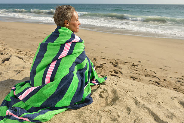 istock Senior Woman Alone on Beach at Sunset 170102934