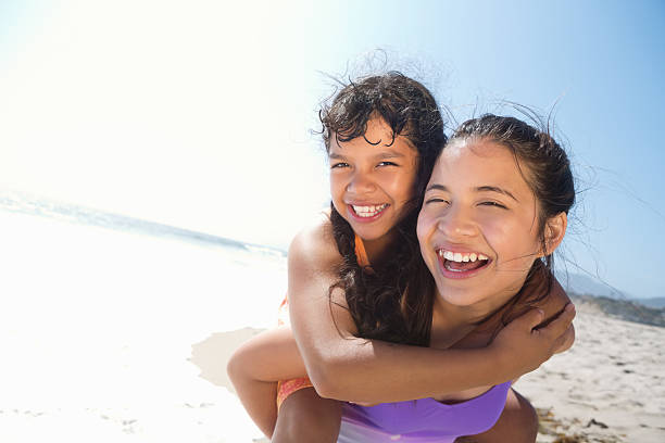 istock Happy sisters playing together on sunny California beach 170103095
