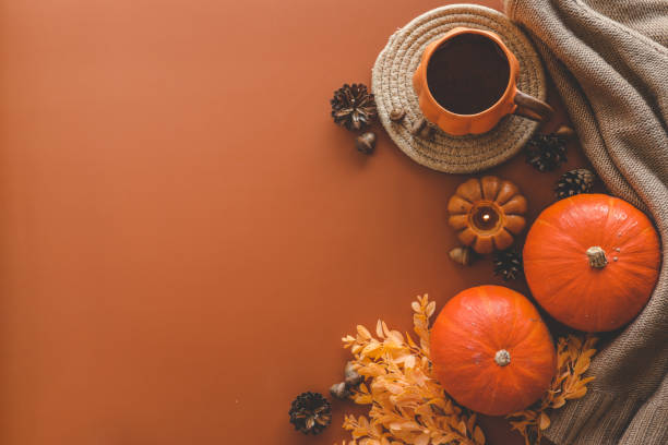 istock Autumn background top view, pumpkin and leaves on orange background 1701032489