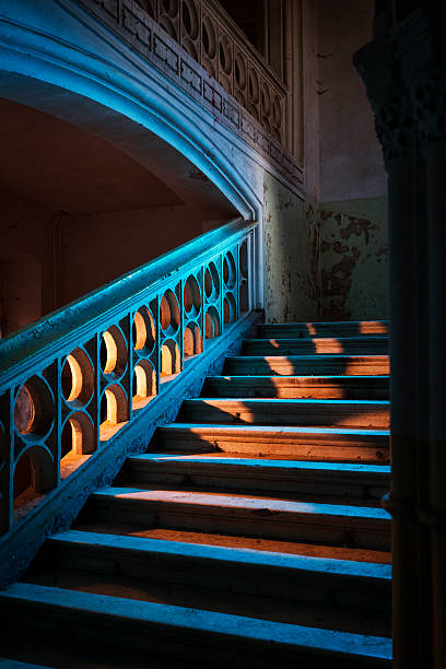 Stairway in abandoned European castle, Slovenia, built cca 1428. Lit with coloured flash gels.