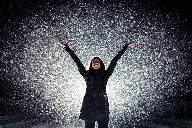 istock Young woman standing in the snow blizzard 170103376