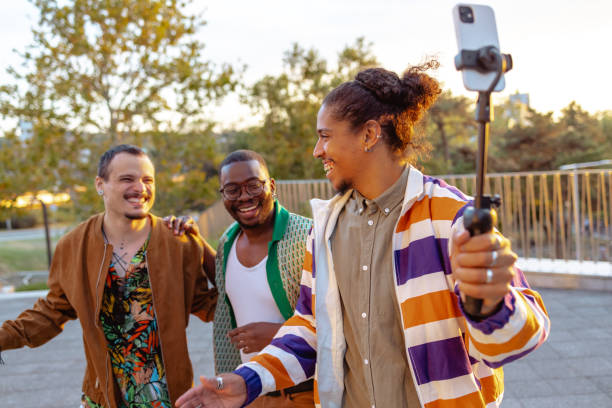 istock Group of male influencers vlogging using mobile phone 1701034880