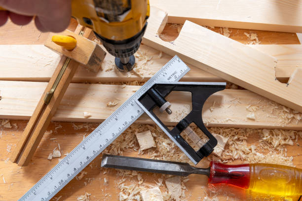 istock A person using a drill on a piece of timber and other carpentry tools on a work bench. 1701041339