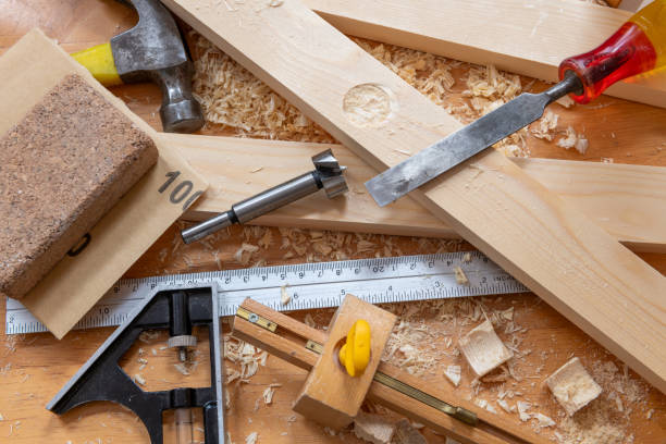istock Timber, wood shavings and carpentry tools on a work bench. 1701043568