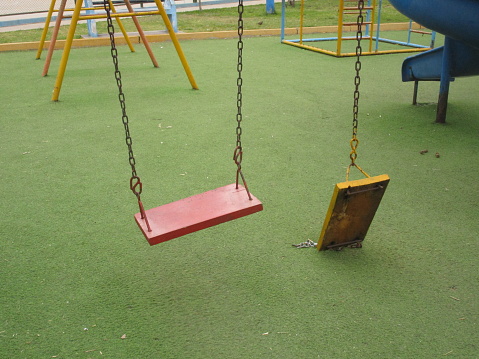Broken swing in public park.