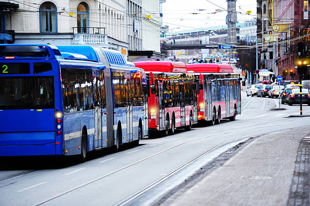Buses in the city traffic City buses, zebra crossing, cars pedestrians etc. stockholm town square sergels torg sweden stock pictures, royalty-free photos & images