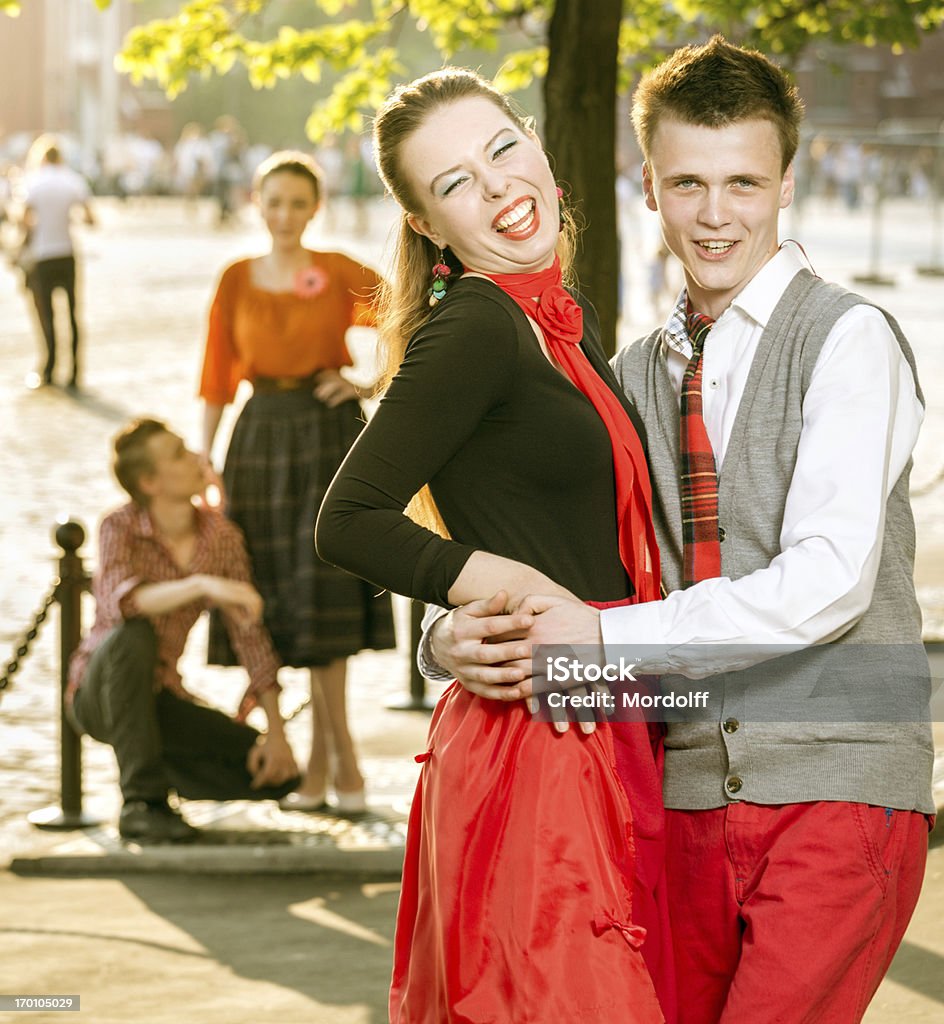Smiling retro couple outdoors Embracing happy beautiful couple standing on street 1950-1959 Stock Photo