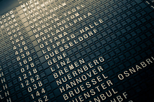 Analog Airport Departure Board An analog "flip" departure board showing destinations at Frankfurt Airport frankfurt international airport stock pictures, royalty-free photos & images