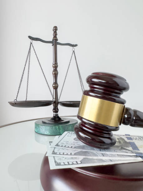 istock Wood gavel, dollar bills and scale of justice 1701053205