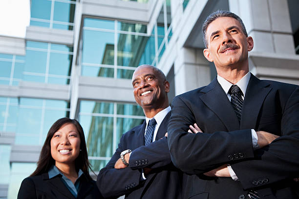 istock Businesspeople standing outside office building 170105532