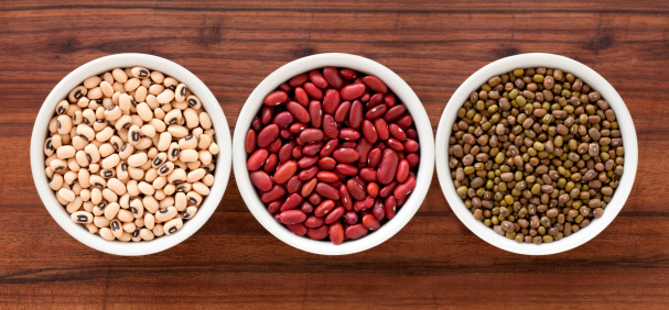 Top view of three bowls containing different types of beans