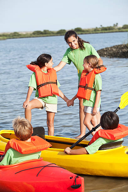 istock Summer camp counselor with children and kayak 170105592