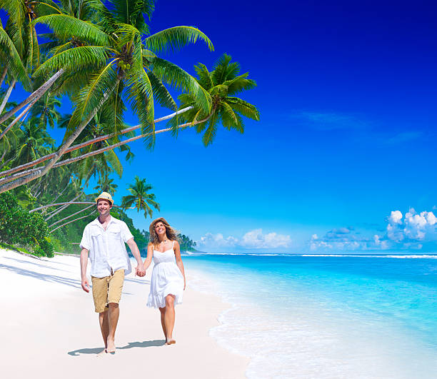 istock Smiling couple walking on tropical beach 170105782