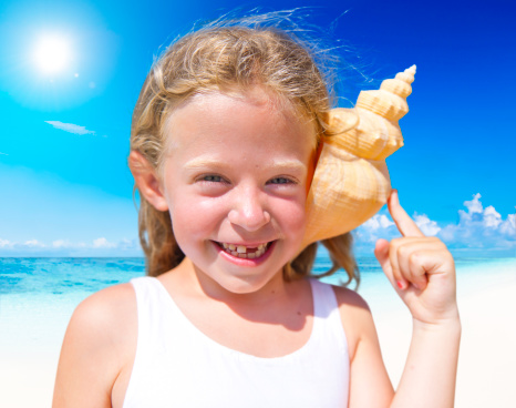 Smiling girl on the beach in summer
