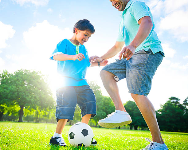 istock Father and son playing football together 170106002