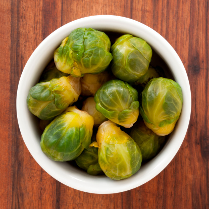 Fresh raw Brussels sproats - white background