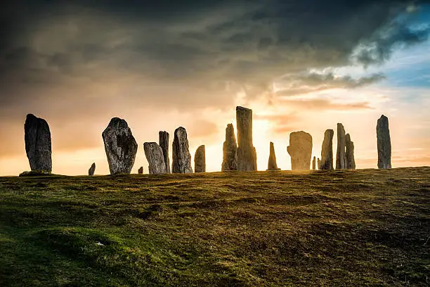 The ancient standing stones of Callanish (or Calanais) on Lewis in the Outer Hebrides of Scotland at sunrise. Built about 5000 years ago, the deeply textured stones of Callanish are arranged in allignments of avenues and a central circle not unlike a celtic cross.