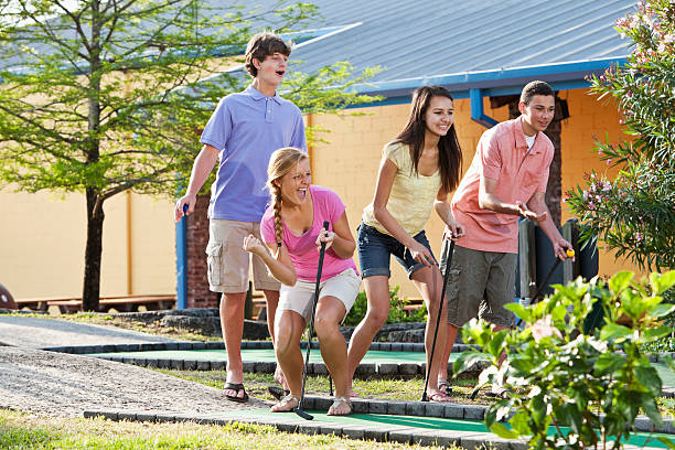 istock Teenage couples playing miniature golf 170107421