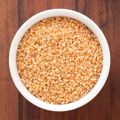 Top view of white bowl full of bulgur wheat