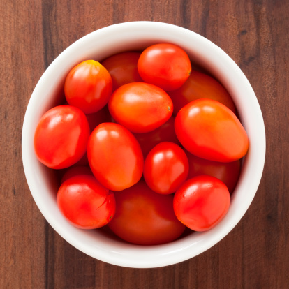 Top view of white bowl full of cherry tomatoes