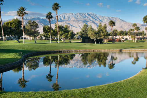 The San Jacinto Mountains reflect off the water on a Palm Springs California golf course.