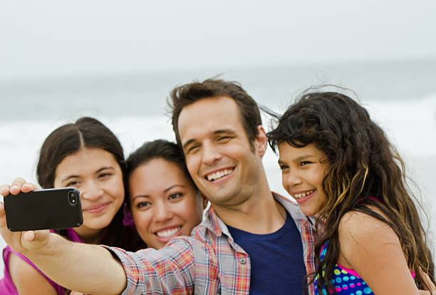 istock Happy family taking self portrait at beach 170107767