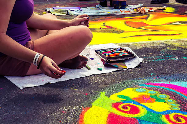 Love Local : Lake Worth Florida Street painting festival Teenagers participating in the Lake Worth street art festival. They are using chalk to make the drawings.  rr jodijacobson stock pictures, royalty-free photos & images