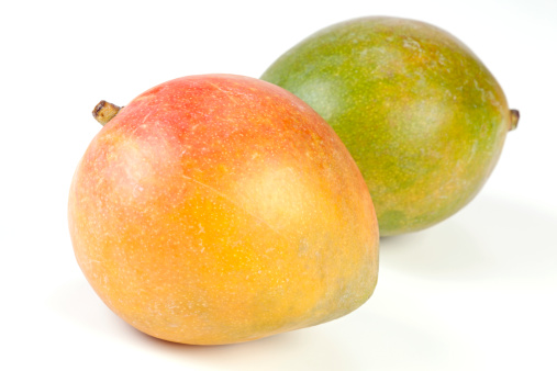 Two Mango isolated on white. Selective focus, shallow DOF.