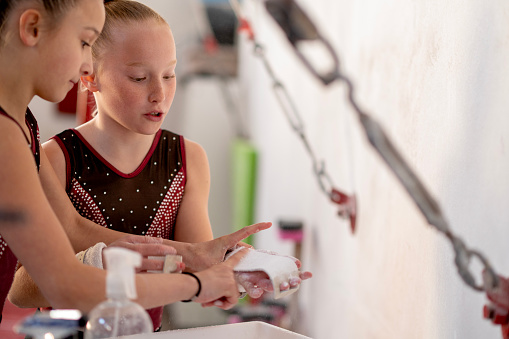 little girls practice artistic gymnastics