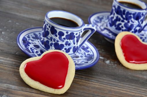 A romantic coffee break for two - freshly baked heart shaped cookies and two espresso coffees.