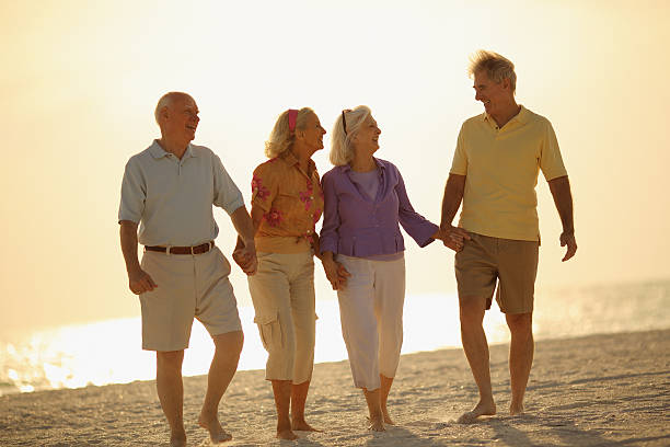 istock Two Senior Couples Having fun at Sunset on beach 170108300