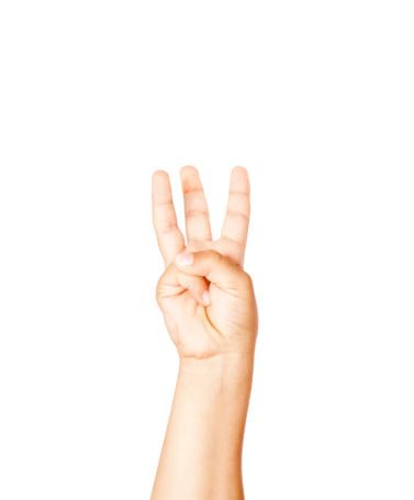 Hispanic child making the letter W in American Sign Language.  OR 3