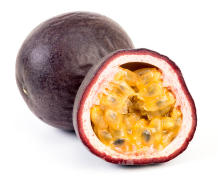 Passion fruit cut in half The flesh is bright yellow. on a white background