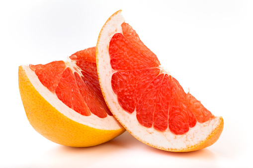 Fresh two slices of red Grapefruit. Isolated on white background.