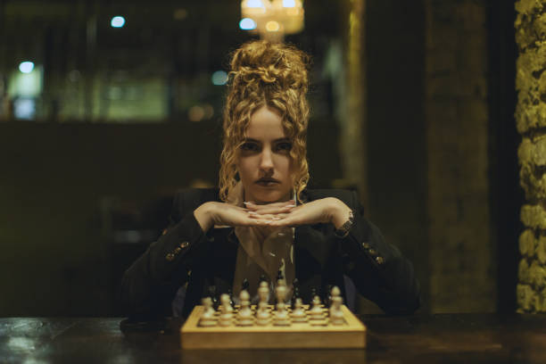 Curly redhead woman playing chess
