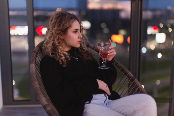 istock Curly redhead woman relaxing on the balcony. 1701121587