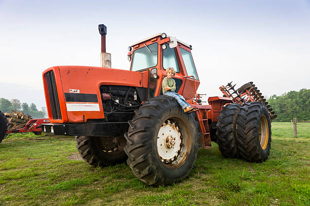 istock Little farm boy on a tractor 170112664