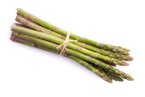 bundle of green asparagus on a white background.